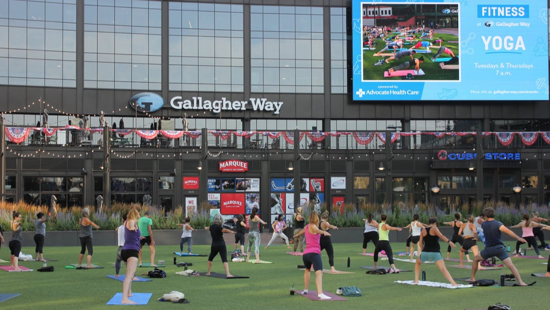 people practicing yoga outdoors at Gallagher Way